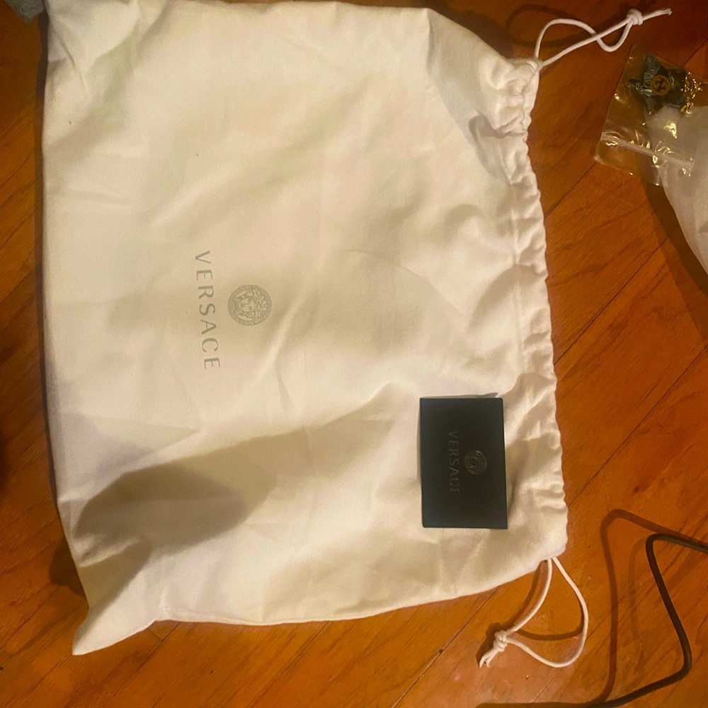 Versace dust bag with authenticity card .